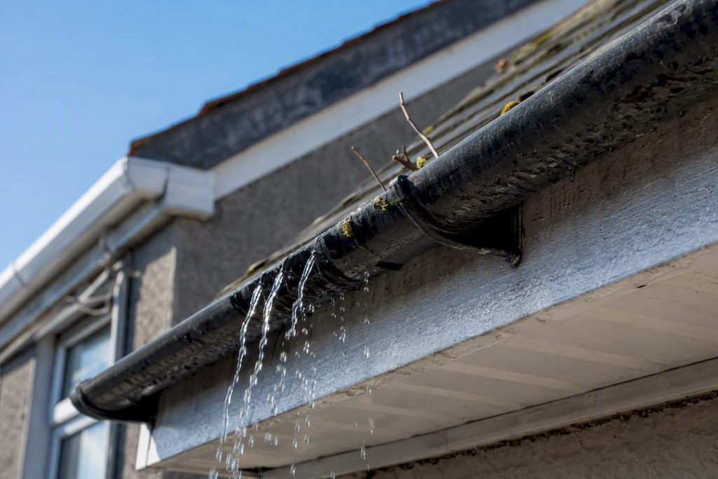 Water flowing through clean roof gutter